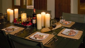 A dining table set with candles, wine glasses, plates of food, and a bottle of wine. - Spacious Villa for 6-8 People plus 2 Babies with Exclusive Pool (Caubon-Saint-Sauveur)