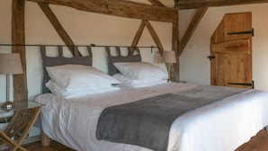 A bedroom with a wooden ceiling, a bed with white bedding, two bedside lamps, and a wooden wardrobe. - Spacious Villa for 6-8 People plus 2 Babies with Exclusive Pool (Caubon-Saint-Sauveur)