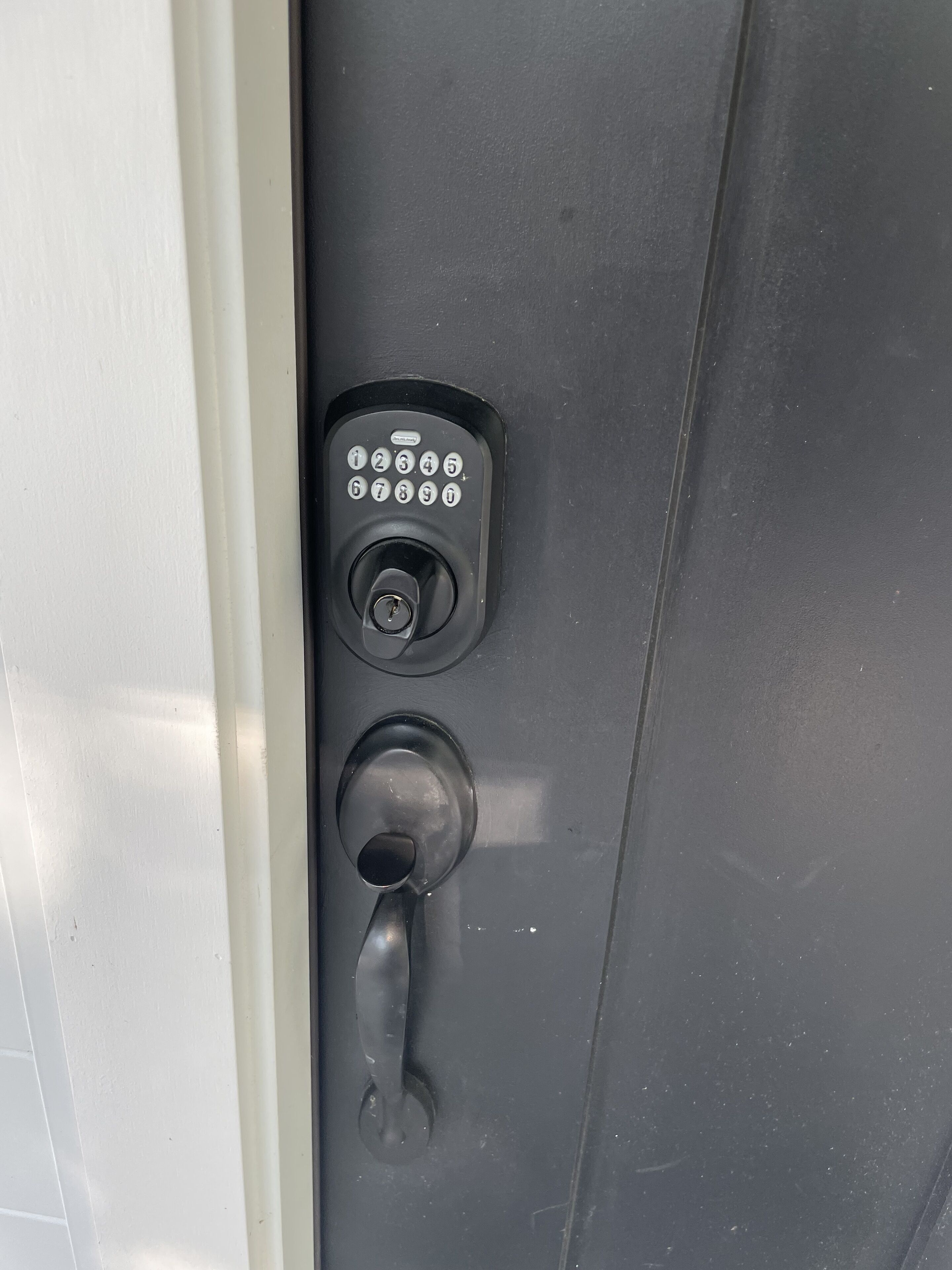 A door with a numeric keypad lock and a keyhole.