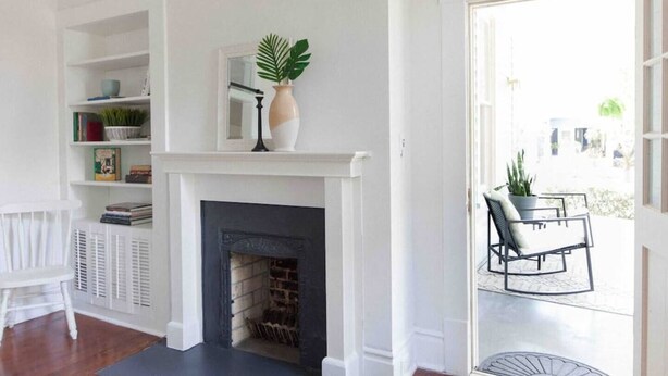 A room with a fireplace, white walls, and a bookshelf. - Three king beds. One place for everyone to land. Come back from the tournament, graduation, or family visit, spread out, sleep incredibly well, and wake up ready for Montgomery again. (Montgomery)