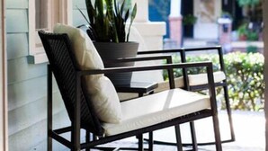 A porch with a chair and a potted plant. - Three king beds. One place for everyone to land. Come back from the tournament, graduation, or family visit, spread out, sleep incredibly well, and wake up ready for Montgomery again. (Montgomery)