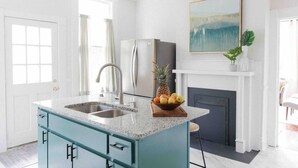 A modern kitchen with a granite countertop, stainless steel sink, and a built-in island with drawers. - Three king beds. One place for everyone to land. Come back from the tournament, graduation, or family visit, spread out, sleep incredibly well, and wake up ready for Montgomery again. (Montgomery)