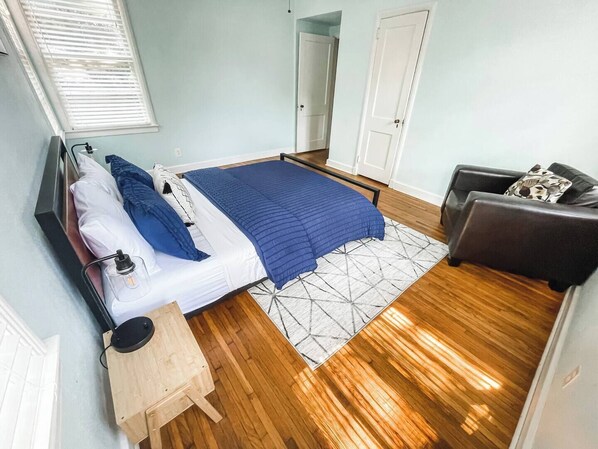 A bedroom with a bed, bedside table, lamp, and a sofa. - Bring the family. Bring the dogs. Spread out, settle in, and make Montgomery feel a lot less like a trip. (Montgomery)