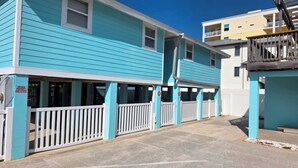 A two-story building with a light blue exterior and white trim. There is a sign indicating private property.