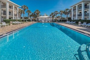 Relax by the pool surrounded by comfortable lounge chairs and stunning views of the surrounding buildings and palm trees.