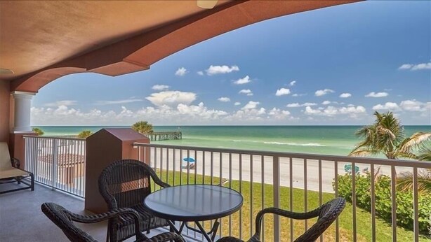 A balcony with a view of the ocean, a table, and chairs. - Luxurious La Contessa Corner unit Directly on the Gulf with Million Dollar Views!~ LC210 (Redington Beach)