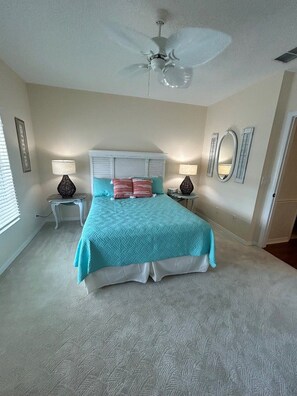 A bedroom with a bed, two bedside tables, a ceiling fan, and a window with blinds. - Amazing Location at the Ship Watch Yacht & Tennis Club 3 month rental~ Ship1815 (Largo)