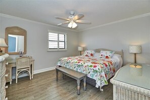 A bedroom with a bed, a desk, a chair, a bench, a ceiling fan, and a window. - Pet Friendly, Direct Gulf Front Condo with Million Dollar Panoramic Views! ~ TP404 (Indian Shores)