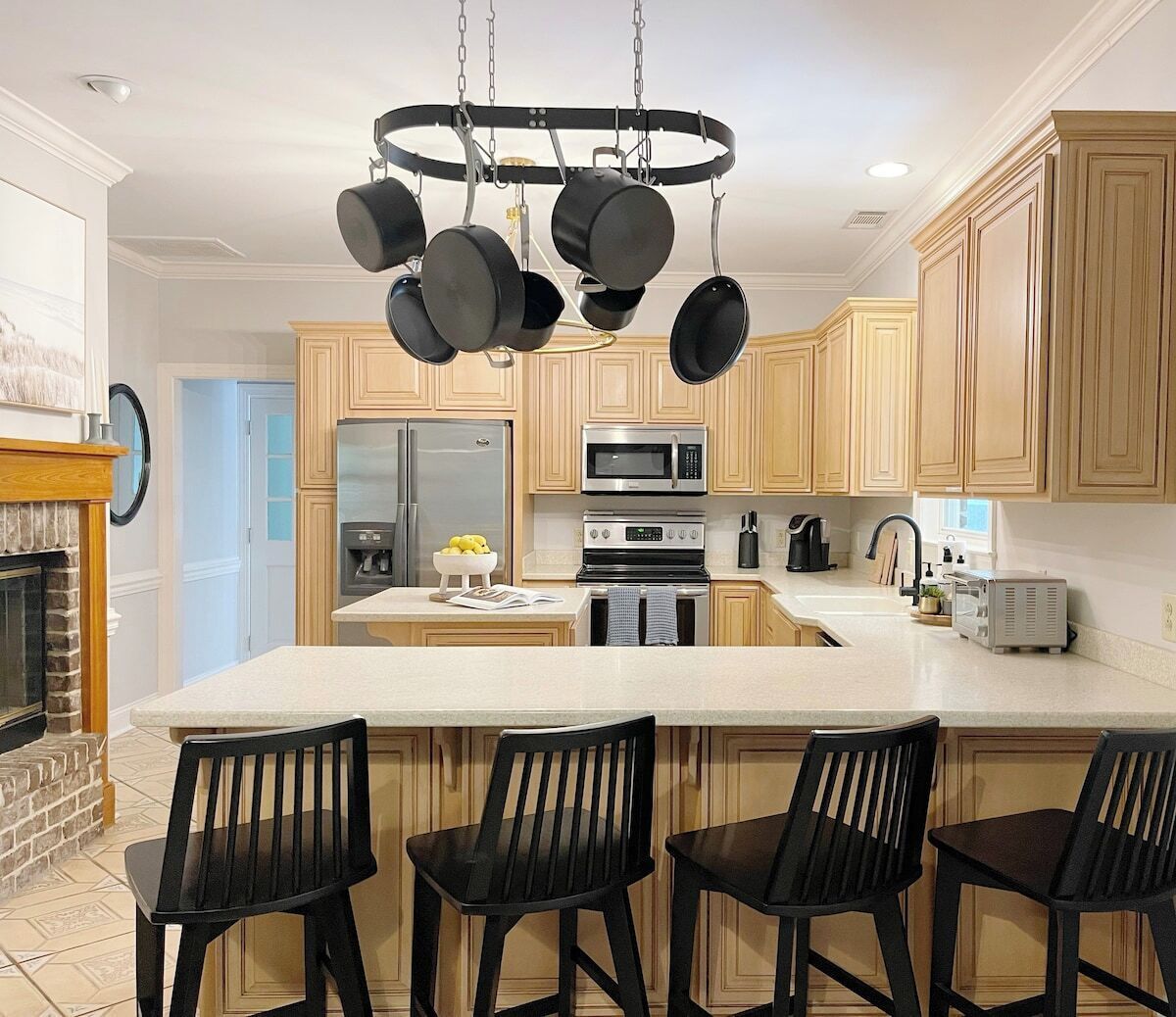 A modern kitchen with a central island, stainless steel appliances, and wooden cabinetry.