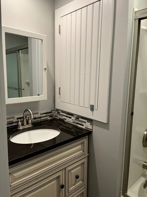 Combined shower/bathtub, towels, soap, toilet paper