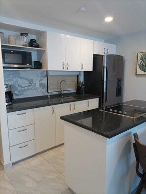 Fridge, microwave, stovetop, coffee/tea maker