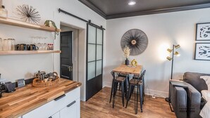A compact living space with a kitchenette, a dining area, and a seating area.