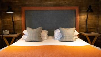 Relax in this inviting space with a large bed, two nightstands, and a comfortable headboard.