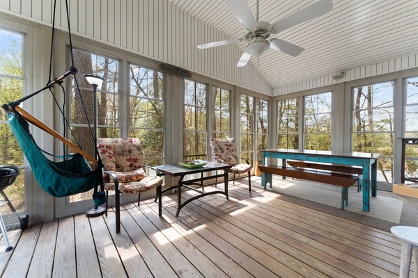 3 season porch with table and plenty of seats. Great for Bar-B-Q.