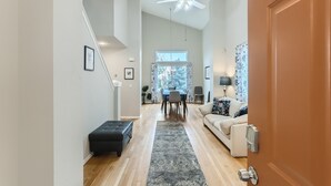 A spacious living room with a sofa, a black ottoman, a patterned rug, and a ceiling fan. - NEW Spacious Home Near Old Town Parker/Tech Ctr (Parker)
