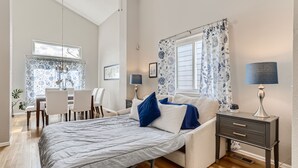 A modern bedroom with a bed, bedside tables, a desk, and chairs. - NEW Spacious Home Near Old Town Parker/Tech Ctr (Parker)
