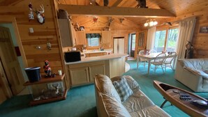 A cozy cabin interior with a living area, kitchen, and dining space. - Quiet "UP NORTH" Cabin with all the Amenities. 200 a night. (Lakewood)
