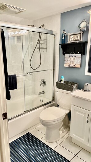 Combined shower/tub, hair dryer, towels, soap