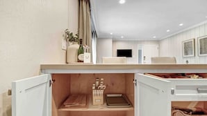 A modern kitchen with wooden cabinets, a countertop, and a sink. - Poolside Retreat | Patio | 10 Min to DT (Napa)