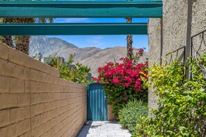 Stroll through a lush garden featuring vibrant flowers and a serene mountain backdrop.