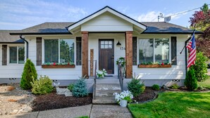 A two-story house with a front porch, a mailbox, and a mailbox number. - The Fir Country Cottage (Philomath)