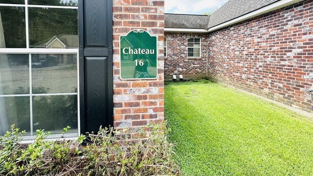 A brick building with a sign reading "Chateau 16". - Chateau 16, spacious townhouse in Tickfaw, LA (Tickfaw)