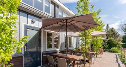 Cosy tiny house on park with playground
