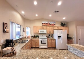 Enjoy cooking in this well-equipped kitchen with a refrigerator, microwave, and oven.