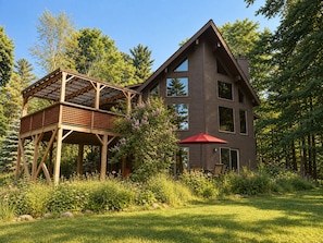 A two-story house with a wooden deck and a red umbrella. - Lake View Berkshire Retreat – Private Setting Near Lenox (Lee)