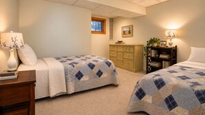 A bedroom with two beds, a dresser, a nightstand, a lamp, a window, and a painting on the wall. - Lake View Berkshire Retreat – Private Setting Near Lenox (Lee)