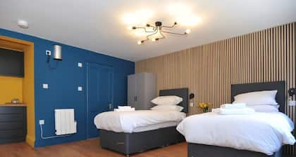 A ground floor studio flat with either double or twin beds, fully equipped kitchen + parking