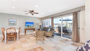 A spacious living area with a dining table, chairs, a sofa, and a ceiling fan. - 4 Bedroom Home Steps from the Sand w/ Balcony&BBQ (Newport Beach)