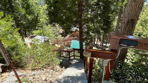 A wooden staircase leading up to a cabin surrounded by trees. - Chalet Yosemite (Yosemite National Park)