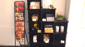 A display rack with various items including a menu, baskets, and small plants. - Stay Airport (Fukuoka)