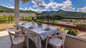 A table set for dining with chairs, a view of mountains, and a clear sky. - Angelina by Interhome (Luino)