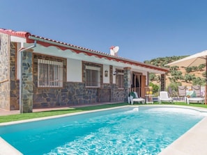 A house with a swimming pool, stone walls, and a satellite dish. - Las Tijeras by Interhome (Cordoba/Rute)