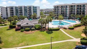 A hotel with multiple buildings, a swimming pool, and well-maintained lawns. - Paradise Found Beachfront Litchfield By the Sea (Pawleys Island)