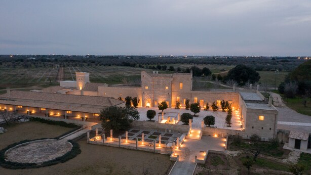 A large, historic building with multiple wings and a courtyard.