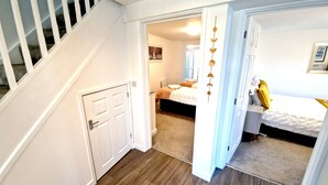 A bedroom with a bed, a nightstand, and a window. - Convenient located. Bright, Spacious , Amazing View Of St Michaels Mount and Sea (Marazion)