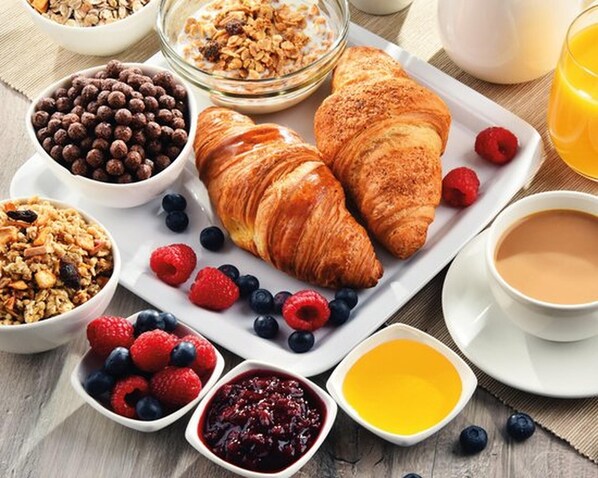 A breakfast setting with croissants, berries, granola, and a cup of coffee. - Apartment Hofer Hof TSCHIGAT with Mountain View, Wi-Fi & Terrace (Algund)