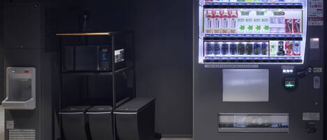 A vending machine with various beverages and a water dispenser.
