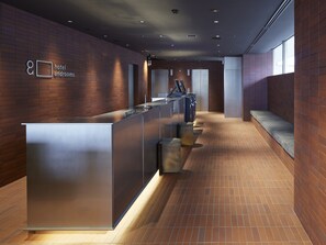 Welcome to our reception area, featuring a sleek desk and comfortable seating.