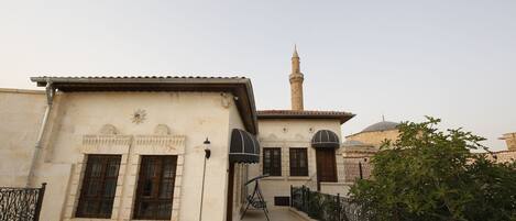 A building with a traditional architectural style, featuring a prominent minaret and arched windows.