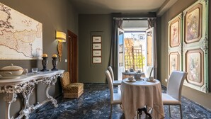 A dining area with a marble floor, a table set for two, and a map on the wall. - Holiday Home 'Casa Neathon' with Wi-Fi, Terrace & Balcony (Noto)