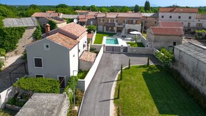 Zona residencial con edificios de piedra, una piscina y cielo despejado.