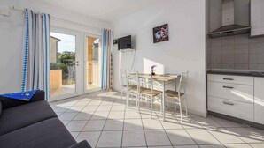 A modern kitchen with white cabinets and a stainless steel range hood. - Holiday apartment with air conditioning near the sea (Lovrečica)