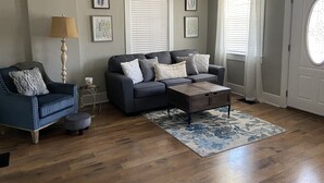 A living room with a sofa, armchair, coffee table, and a rug. - Beautiful Benton Beauty (Saint Charles)
