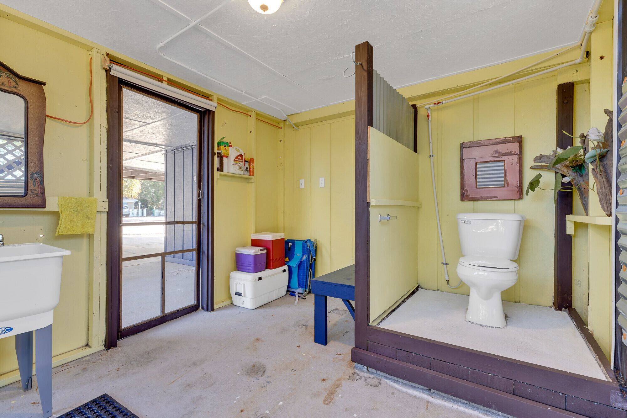 A bathroom with a toilet, sink, and a shower area.
