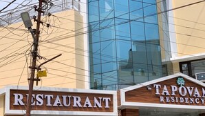 Un edificio con un letrero que dice 'RESTAURANT' y un letrero que dice 'TAPOVAN RESIDENCY'.