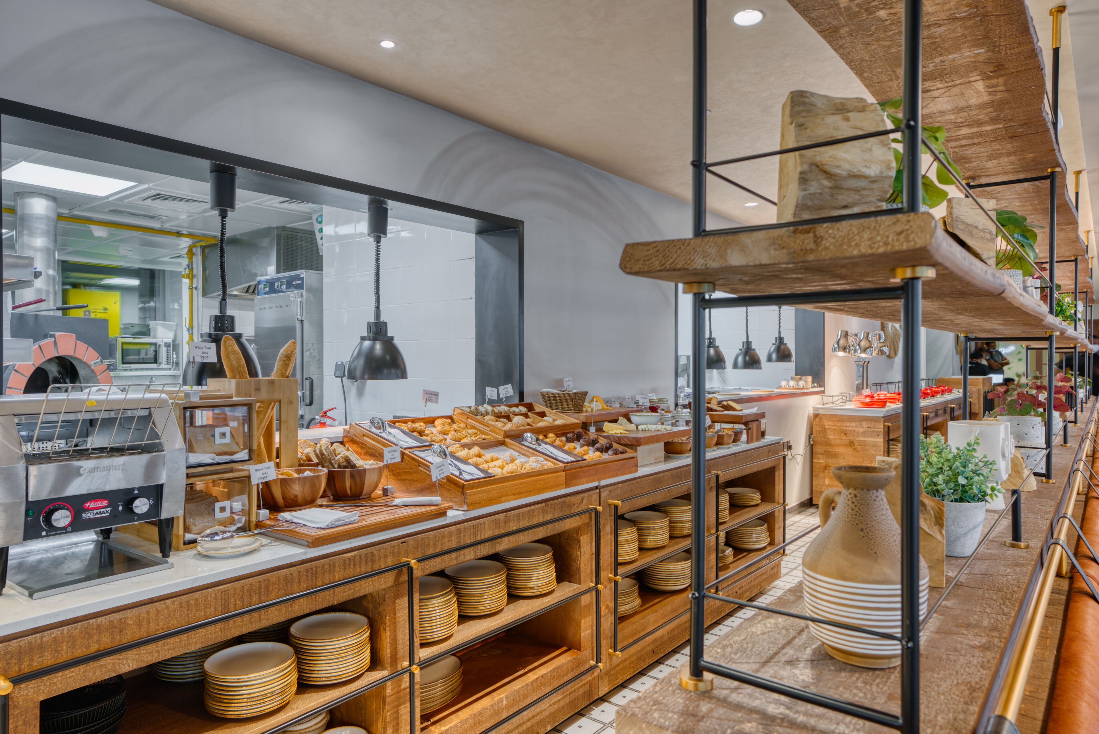 A bakery counter with various baked goods and a coffee machine.